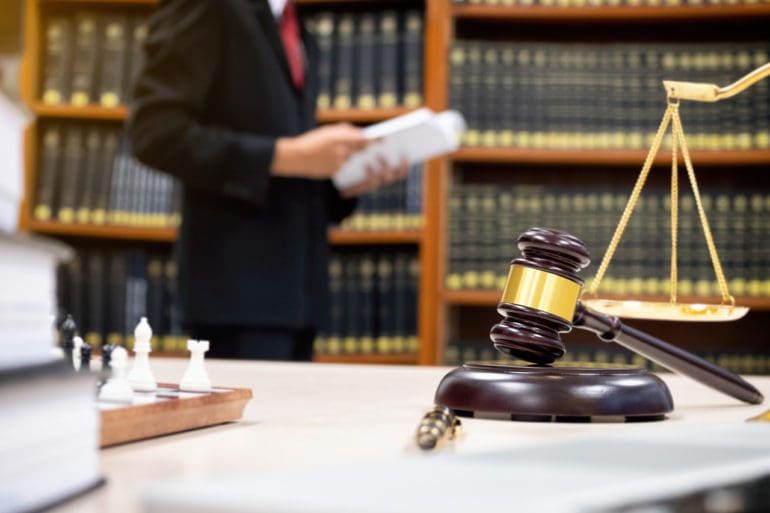 Detail of a judge sitting at his desk.